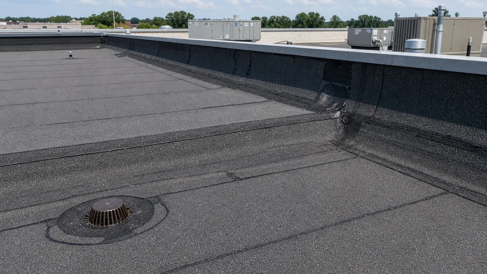Torch-on flat commercial roof with drain