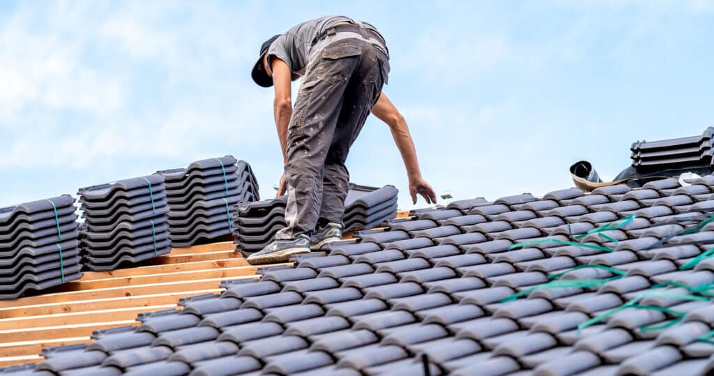 Roofer installing new tile roof