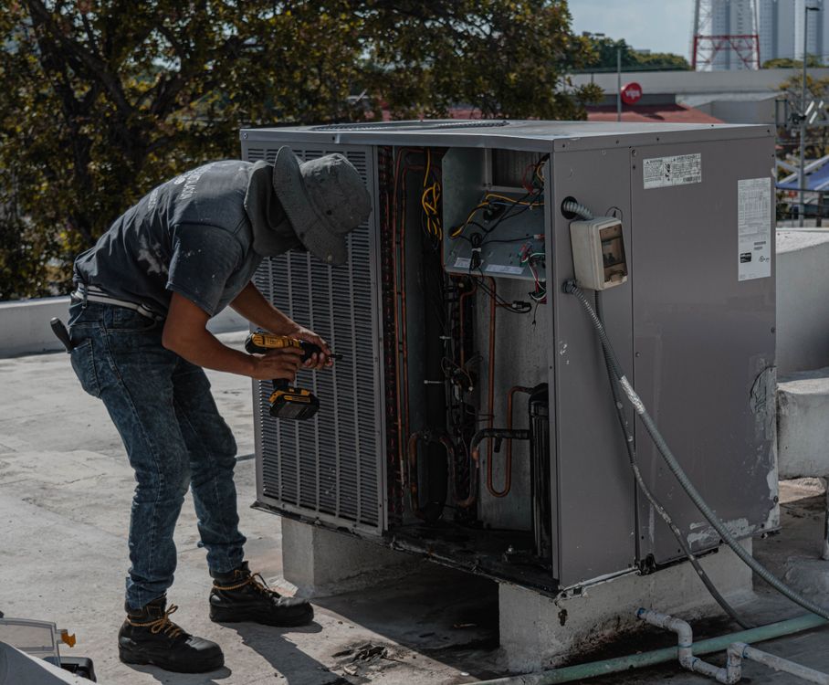 Technician at work for Aquatech Heating & Air Conditioning