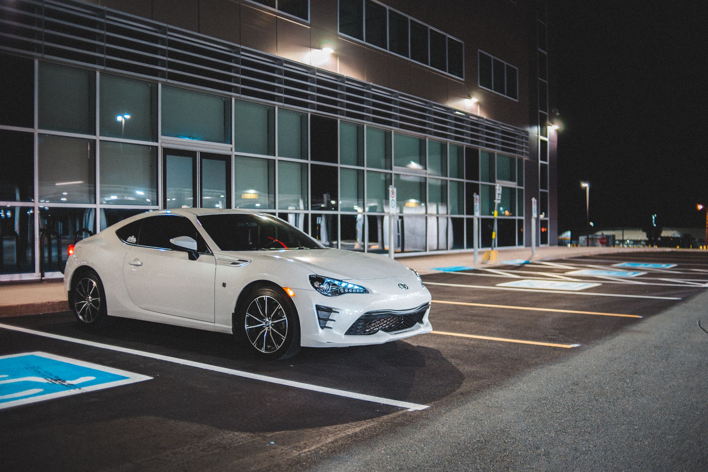 Freshly detailed white sports car at night
