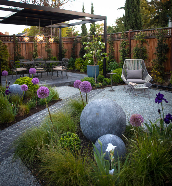 Backyard landscape with stone planters, patio and layered native plantings