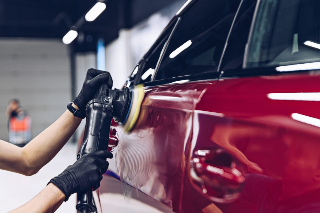 Detailer machine-polishing a car's paintwork