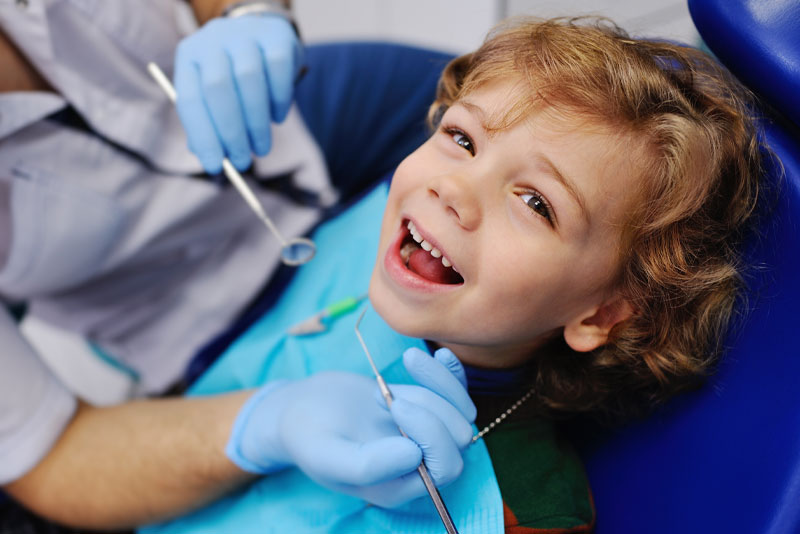 A young patient smiling during a dental visit