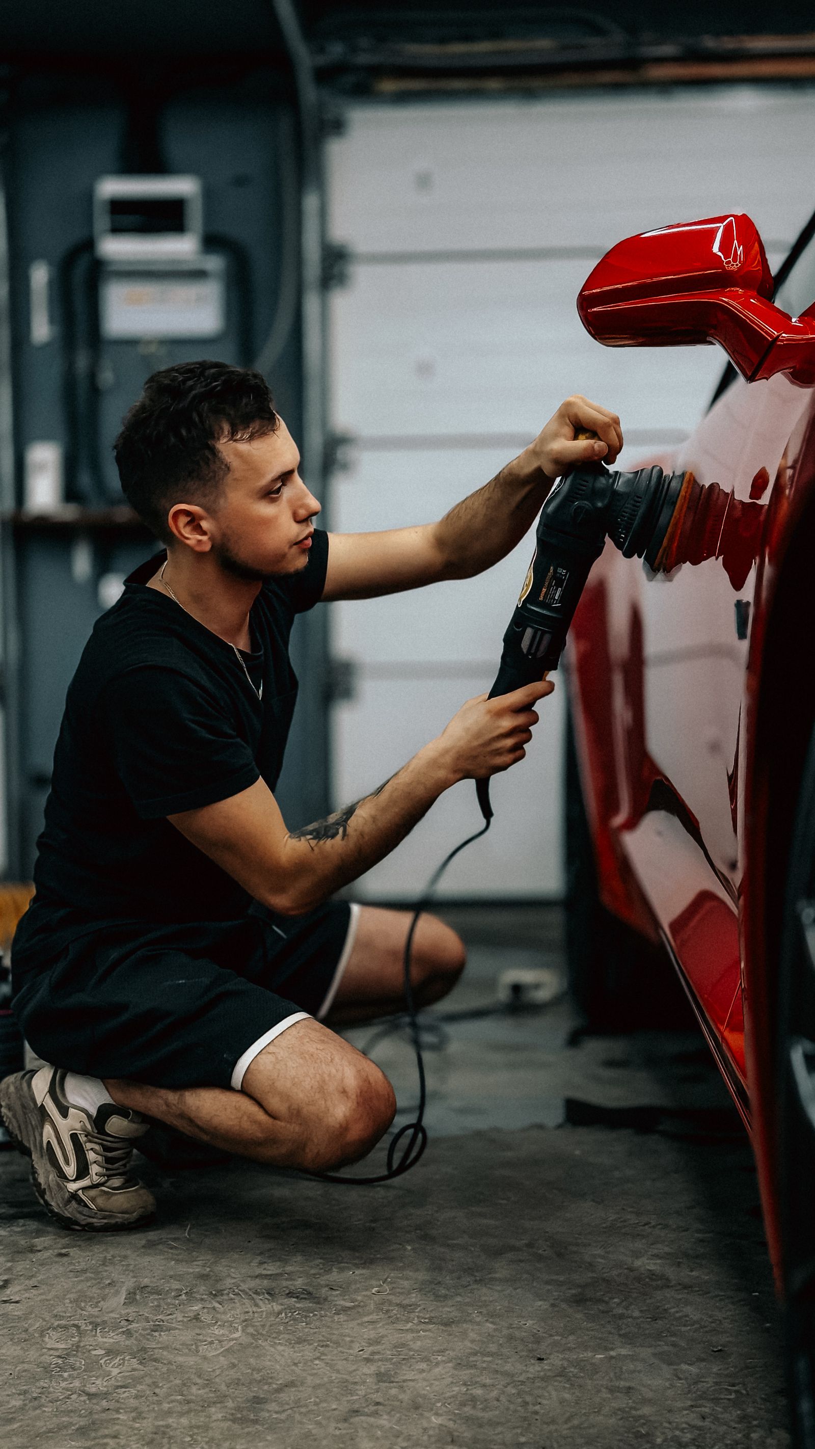Technician detailing a vehicle