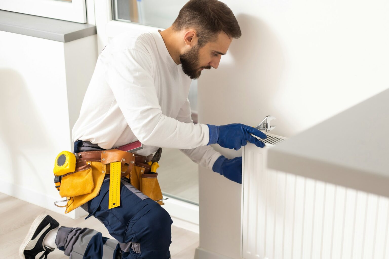 Close-up of radiator repair with a wrench