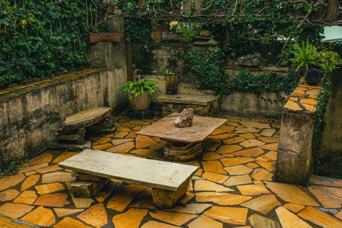 Stone patio courtyard with planted beds