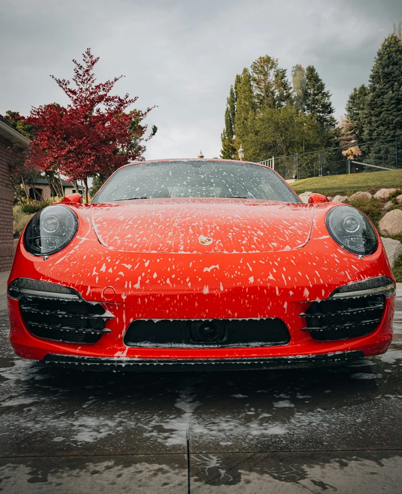 Car covered in wash foam during a mobile detail