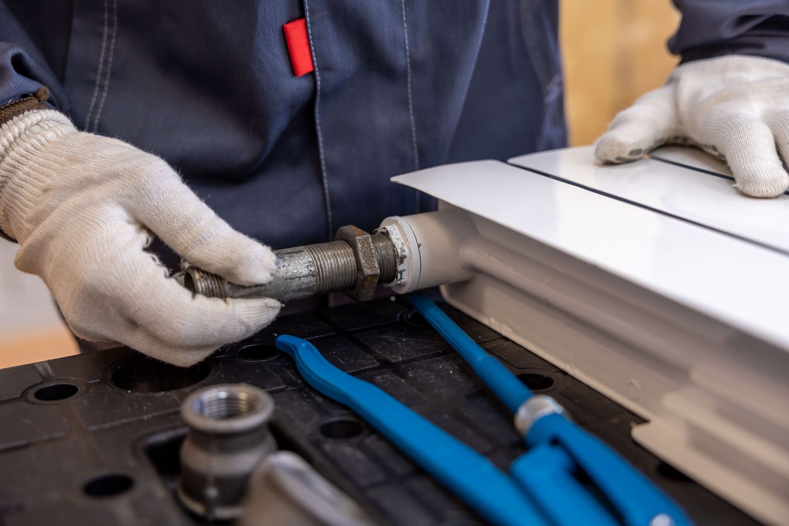 Plumber installing pipework on a residential job
