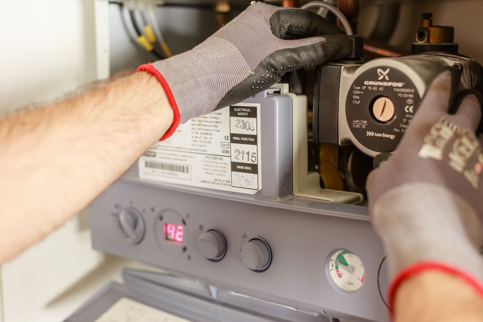 Illustrative photo — plumber at work (sample imagery)