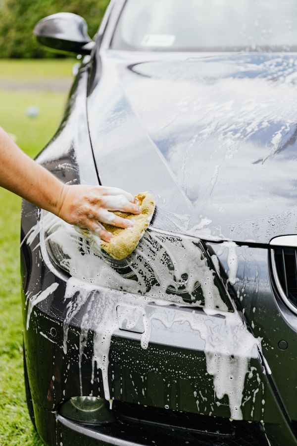 Car covered in foam during hand wash