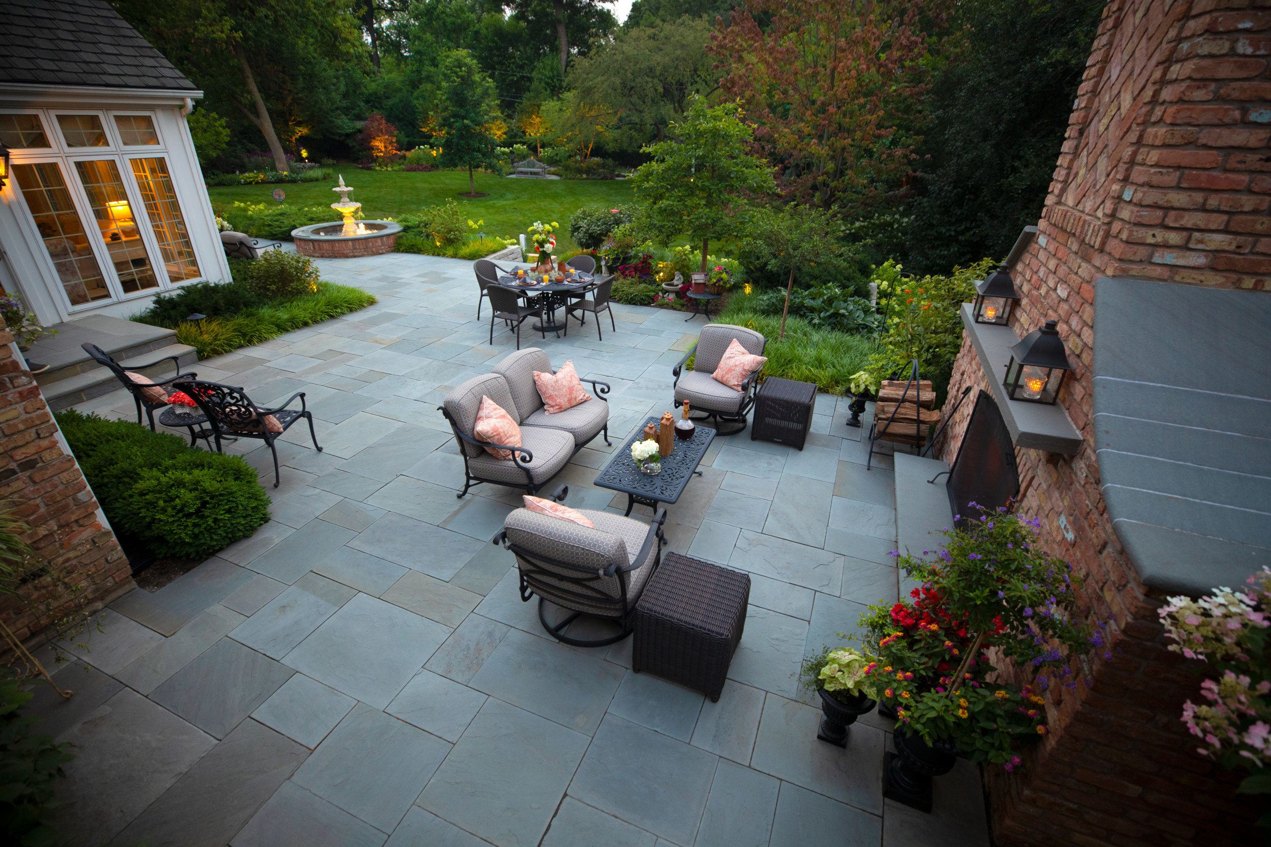 Stone patio at dusk with outdoor furniture (illustrative stock photo)