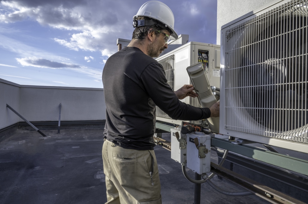 Technician servicing rooftop unit