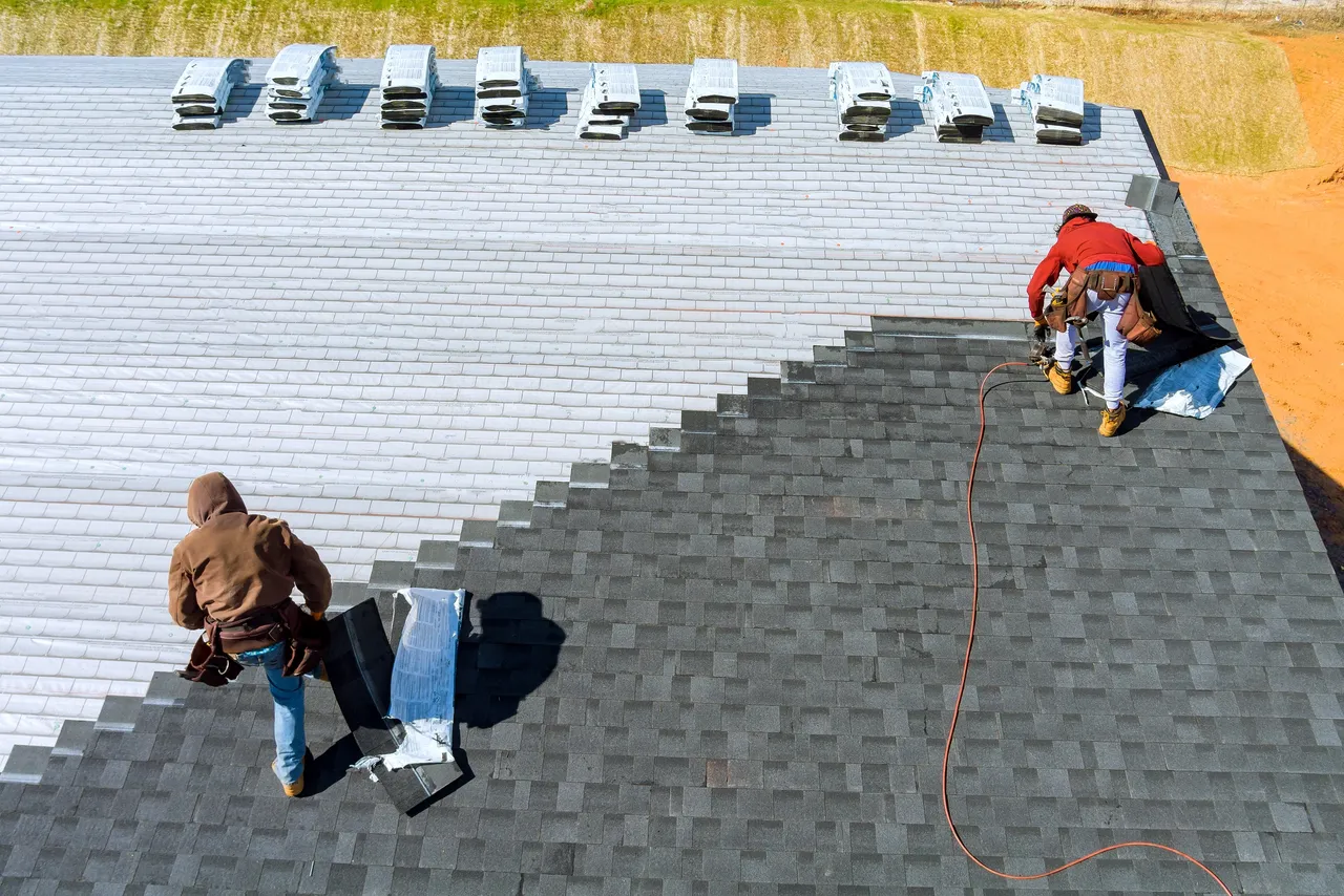 Sample image — roofers installing asphalt shingles on a Houston home