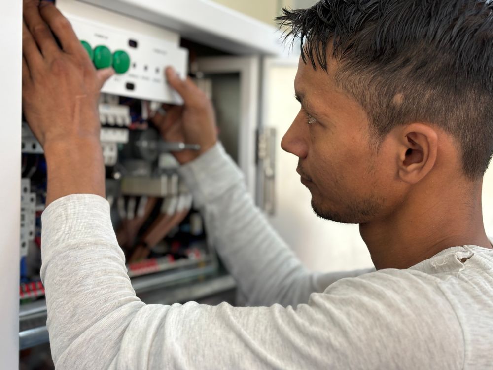 Electrician adjusting a circuit breaker panel
