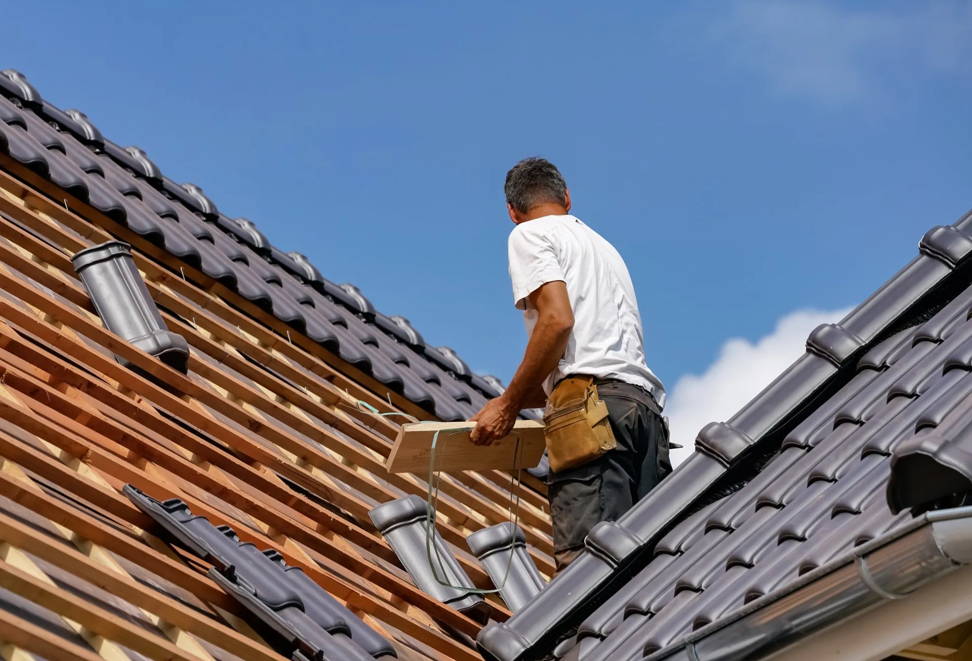 Roofer at work on a pitched roof in Leeds