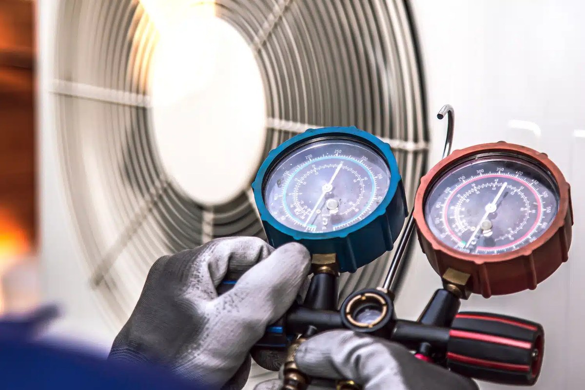 Technician's manifold gauges during a heat pump service call