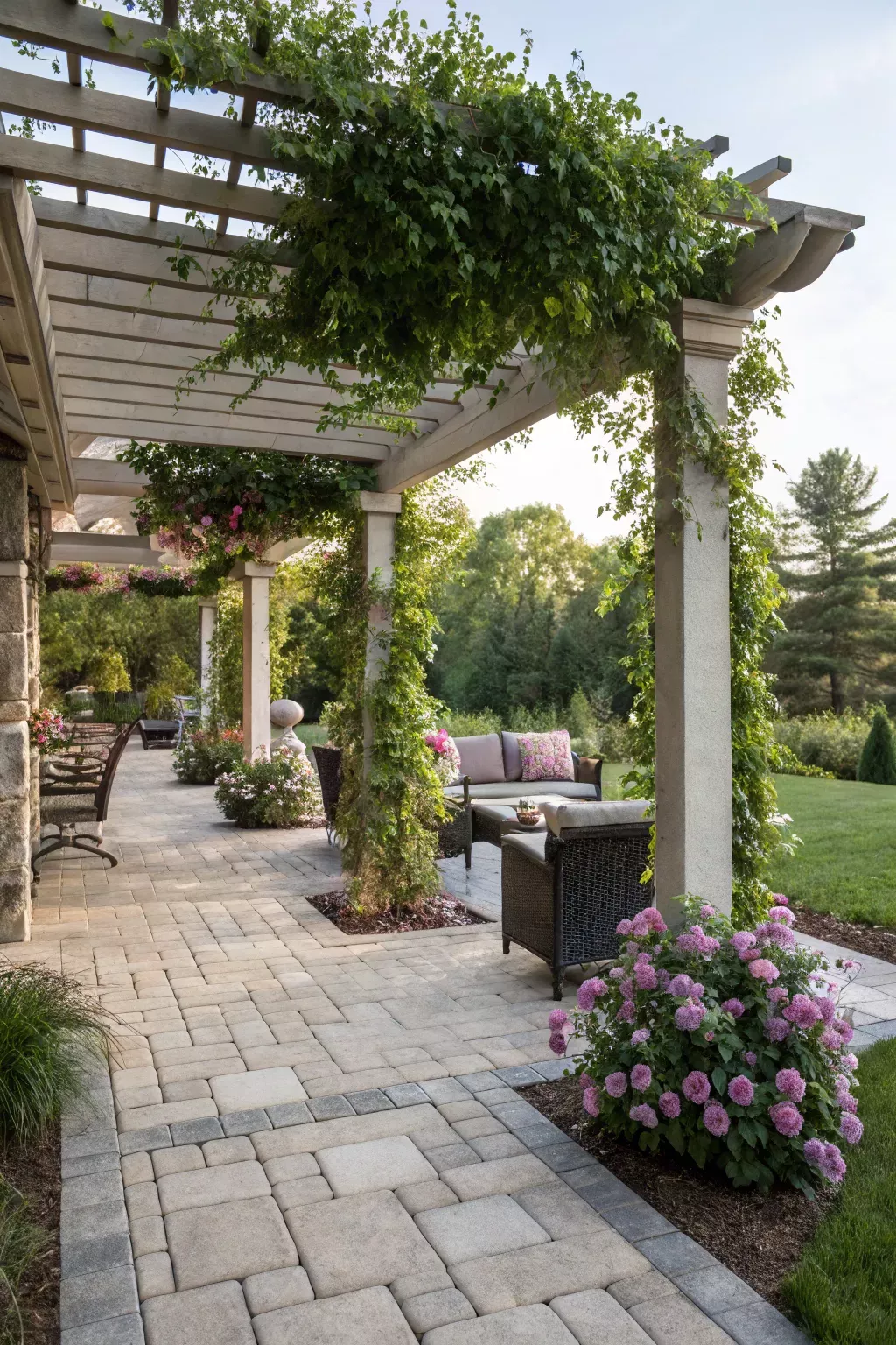 Stone patio with pergola surrounded by native Texas planting at golden hour