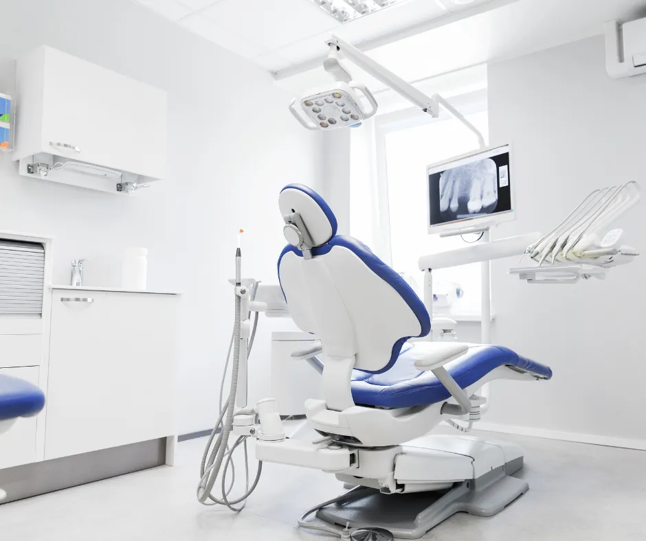 Bright modern dental treatment room with dental chair