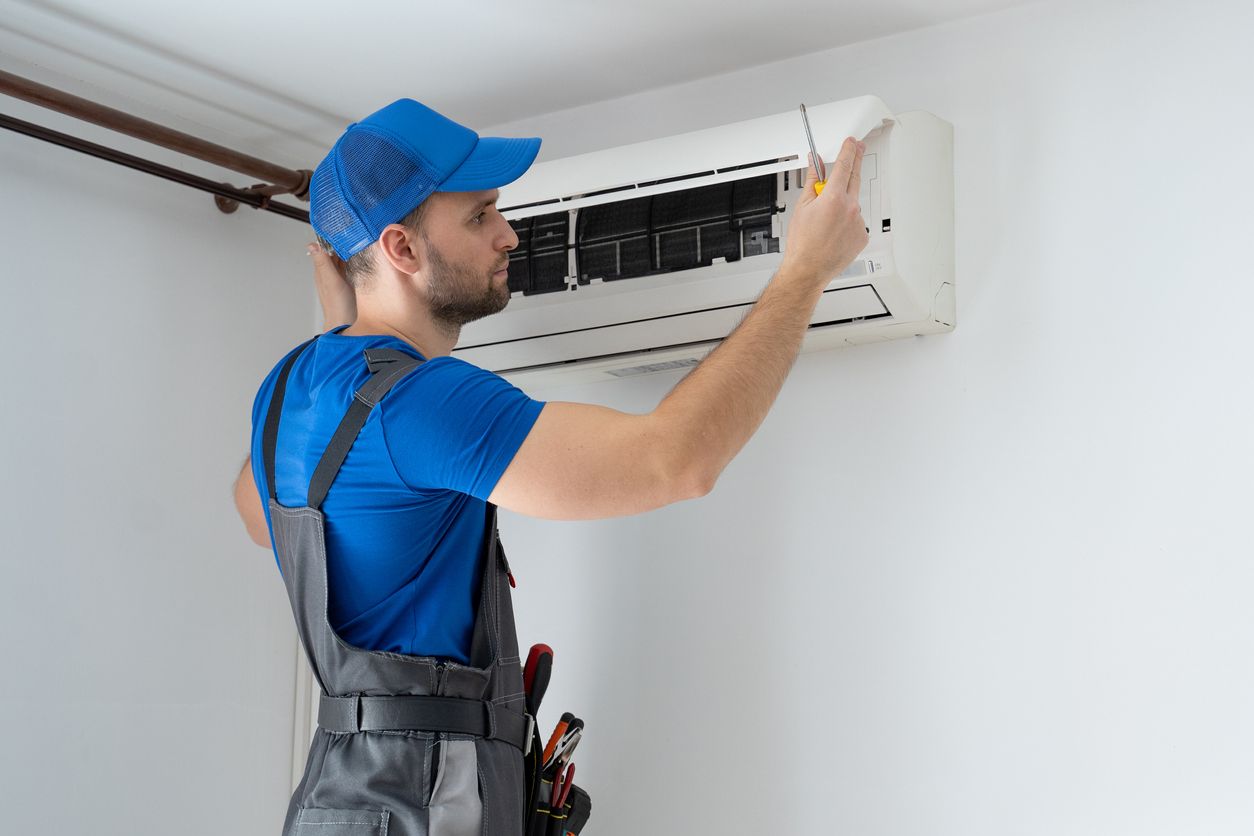 Technician at work on heating equipment