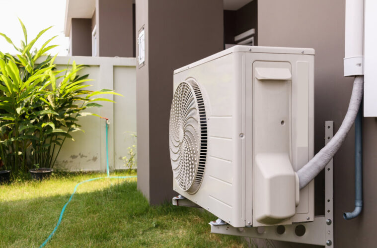 Outdoor air conditioning unit installed beside a home