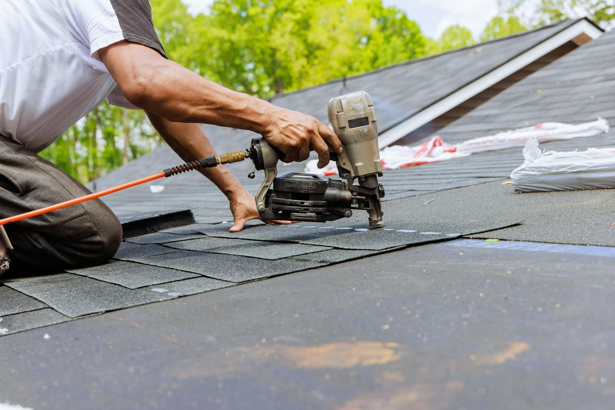 Nail gun fastening roofing material