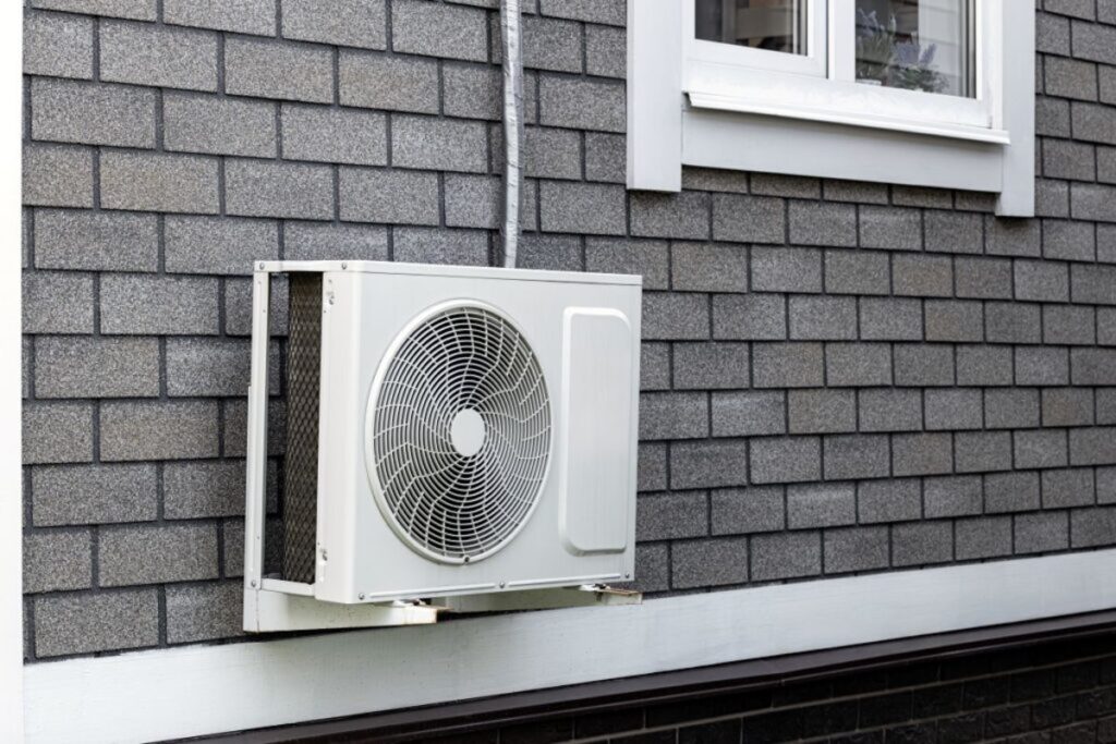 Outdoor air conditioning unit mounted beside a Houston home