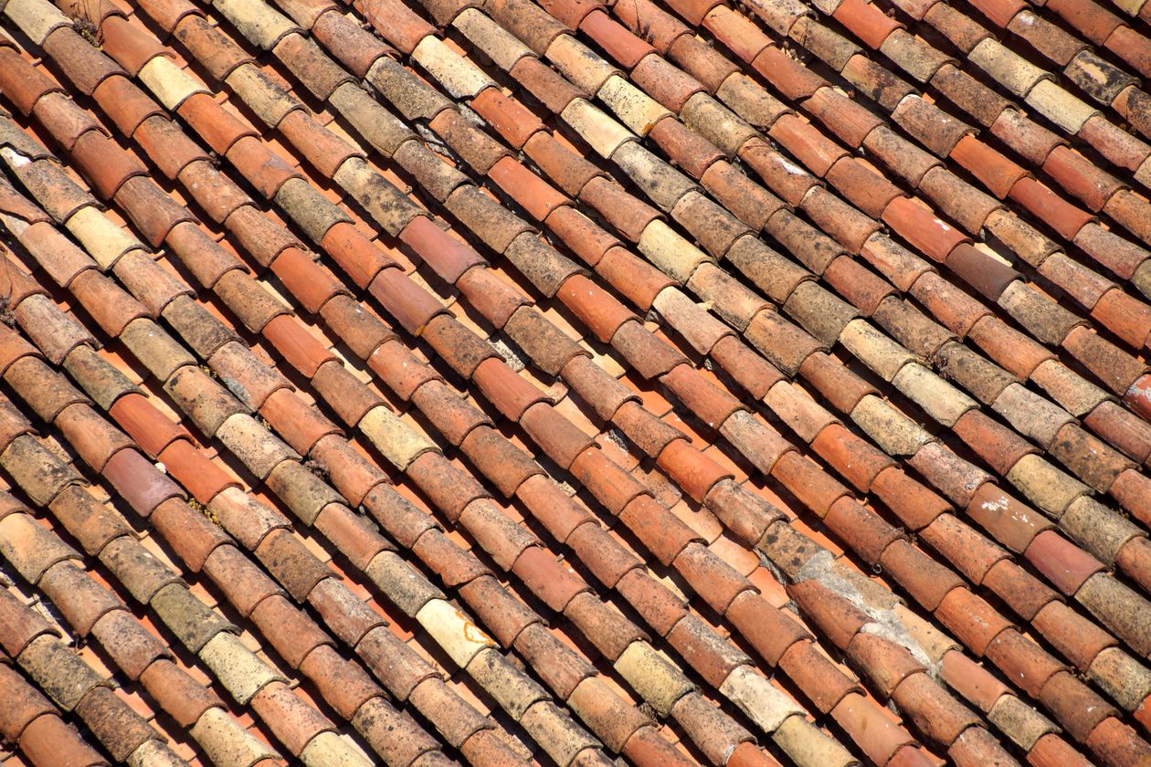 Weathered terracotta roof tiles, close-up — illustrative stock photo, not an actual Hardacker Roofing job