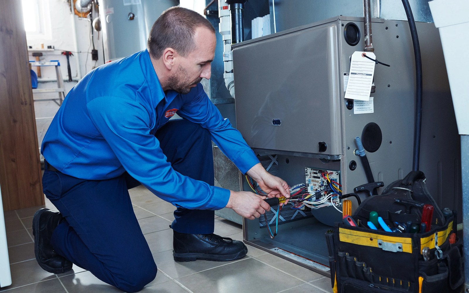 Technician servicing a residential furnace