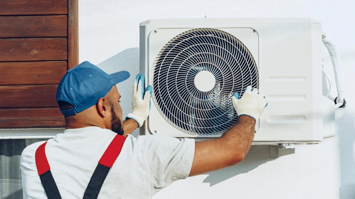 Technician installing an outdoor air conditioning unit