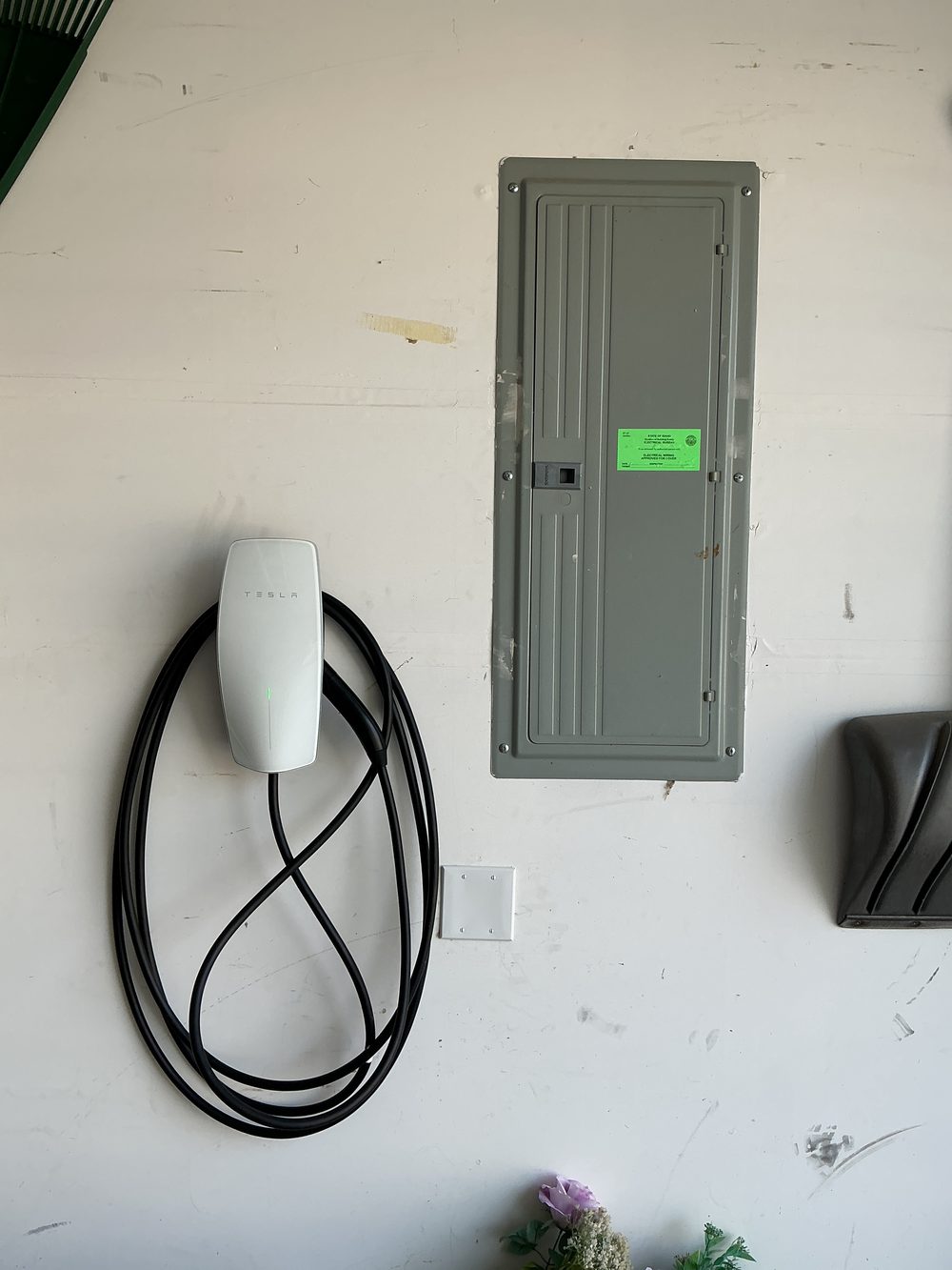 Home EV charger installed on a garage wall