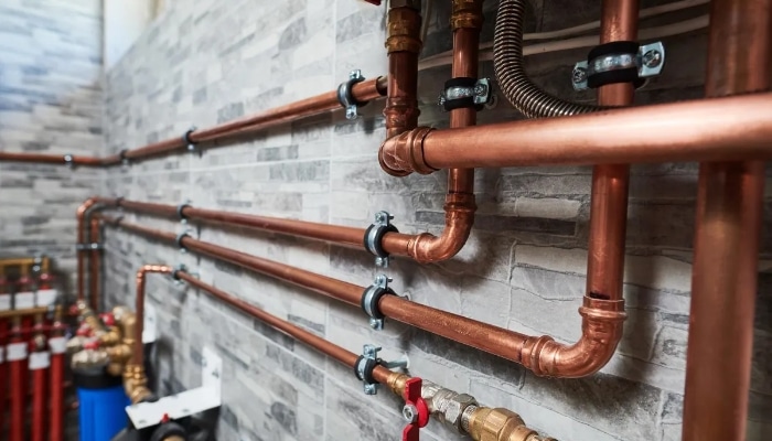 Copper pipework installed on a commercial building wall