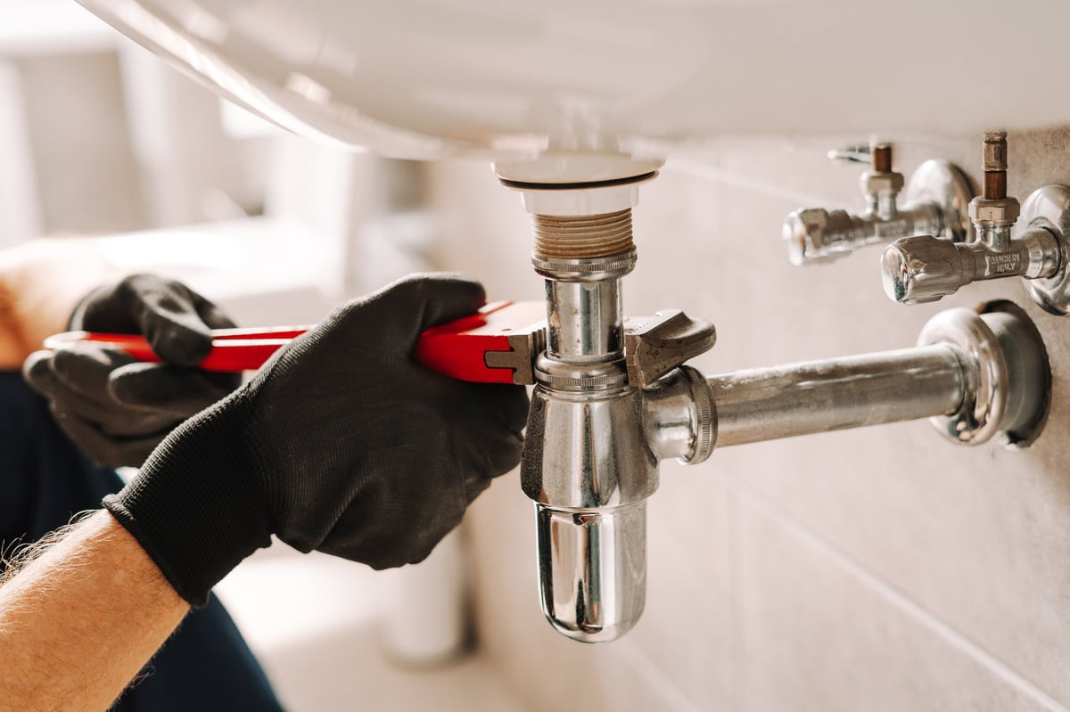 Plumber at work on site