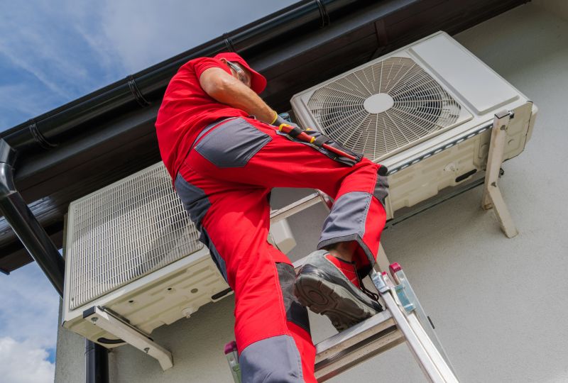 Technician servicing outdoor AC units