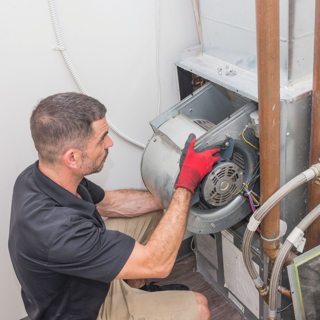 Illustrative stock photo: engineer repairing a boiler