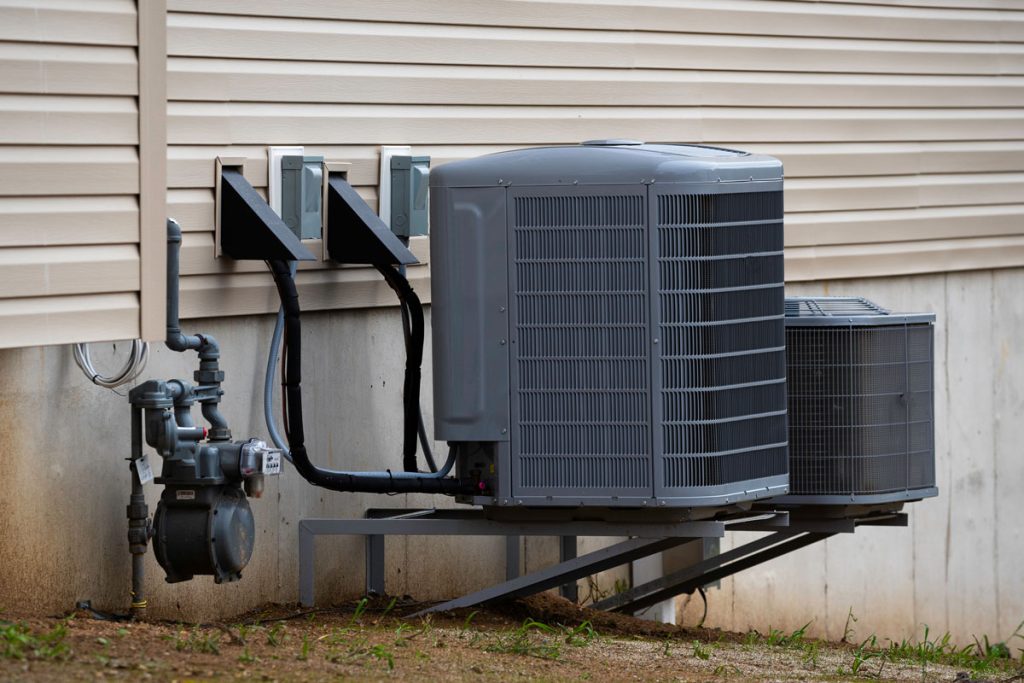 Newly installed central air conditioning unit outside a Toronto home