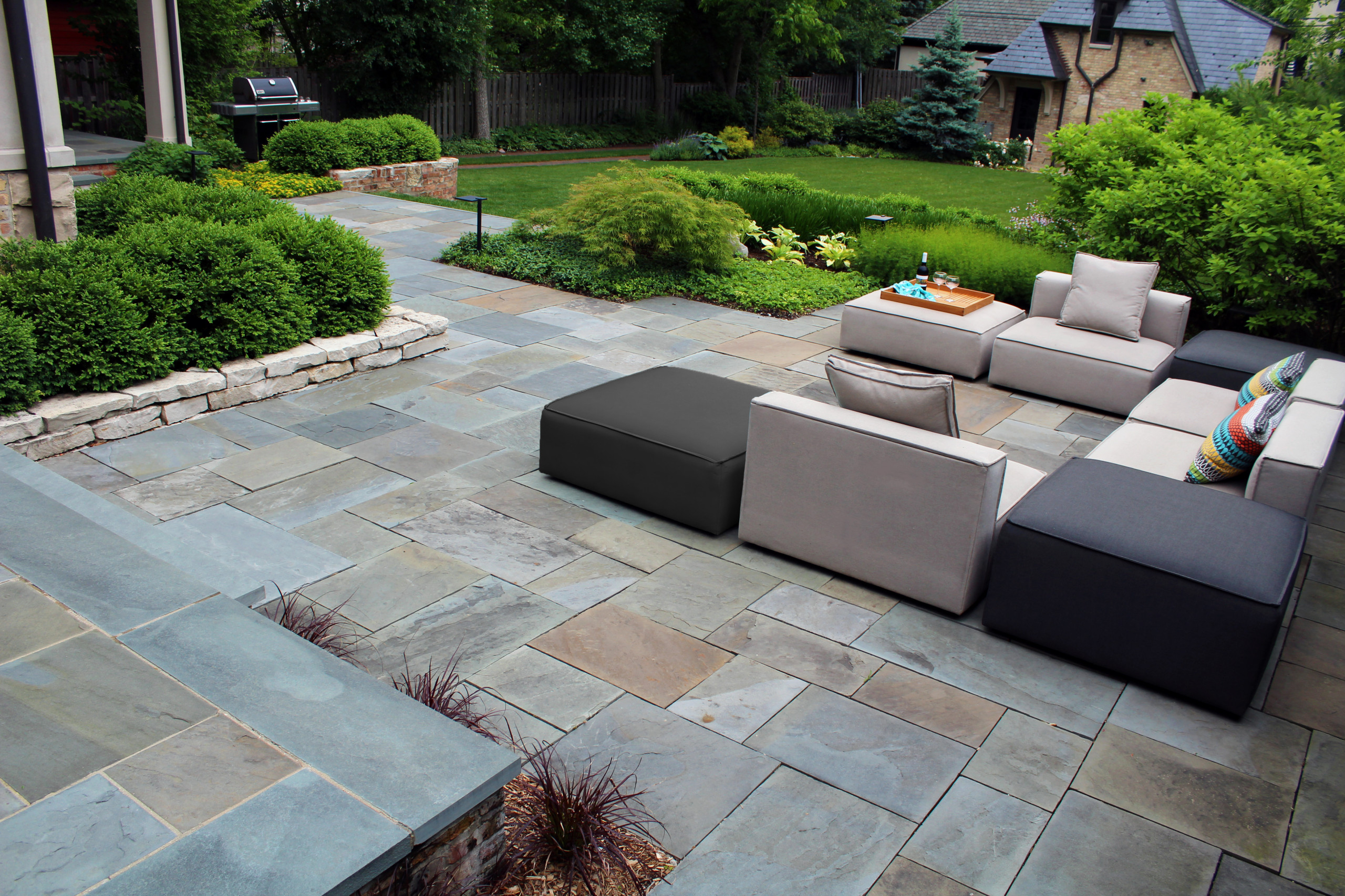 Stone patio and landscaped backyard