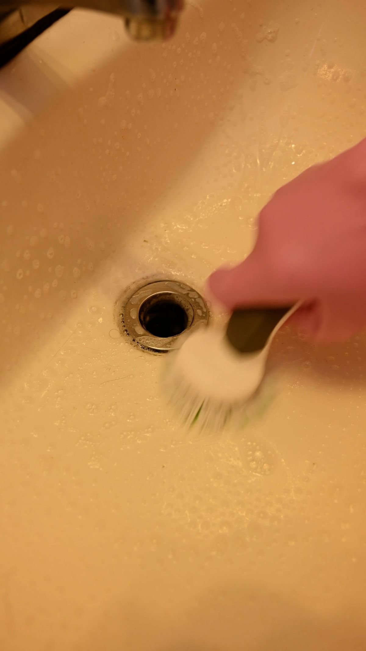 Technician cleaning a drain