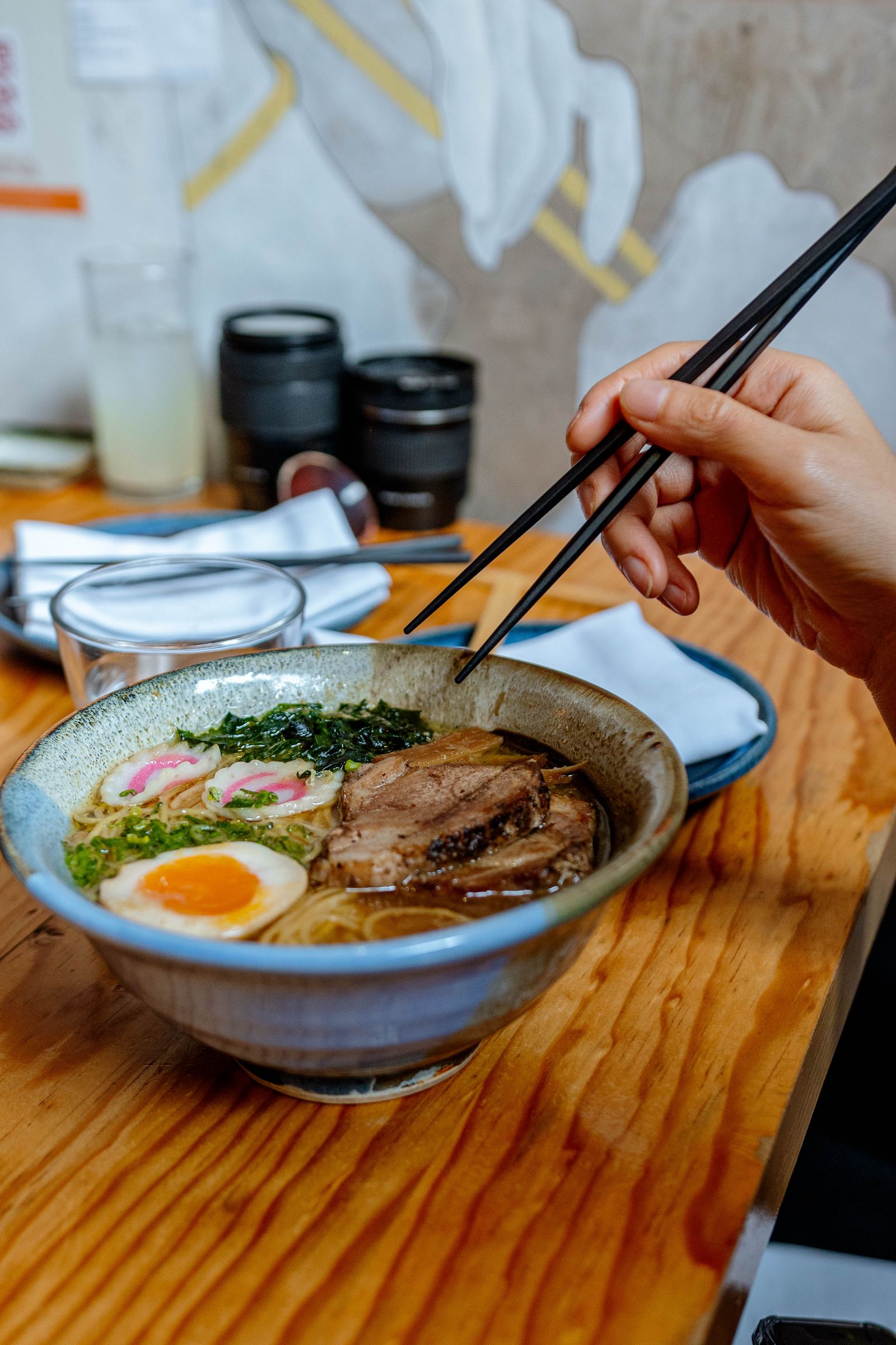 A bowl of Musoshin-style ramen with chashu, seasoned egg and greens