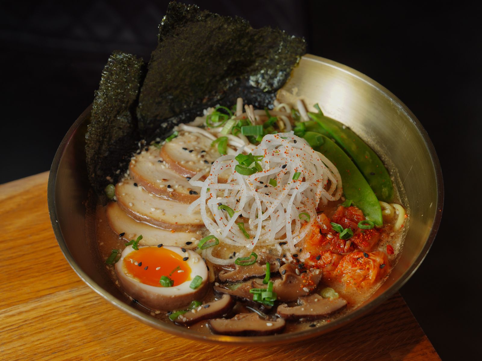 A bowl of ramen with nori on a restaurant table