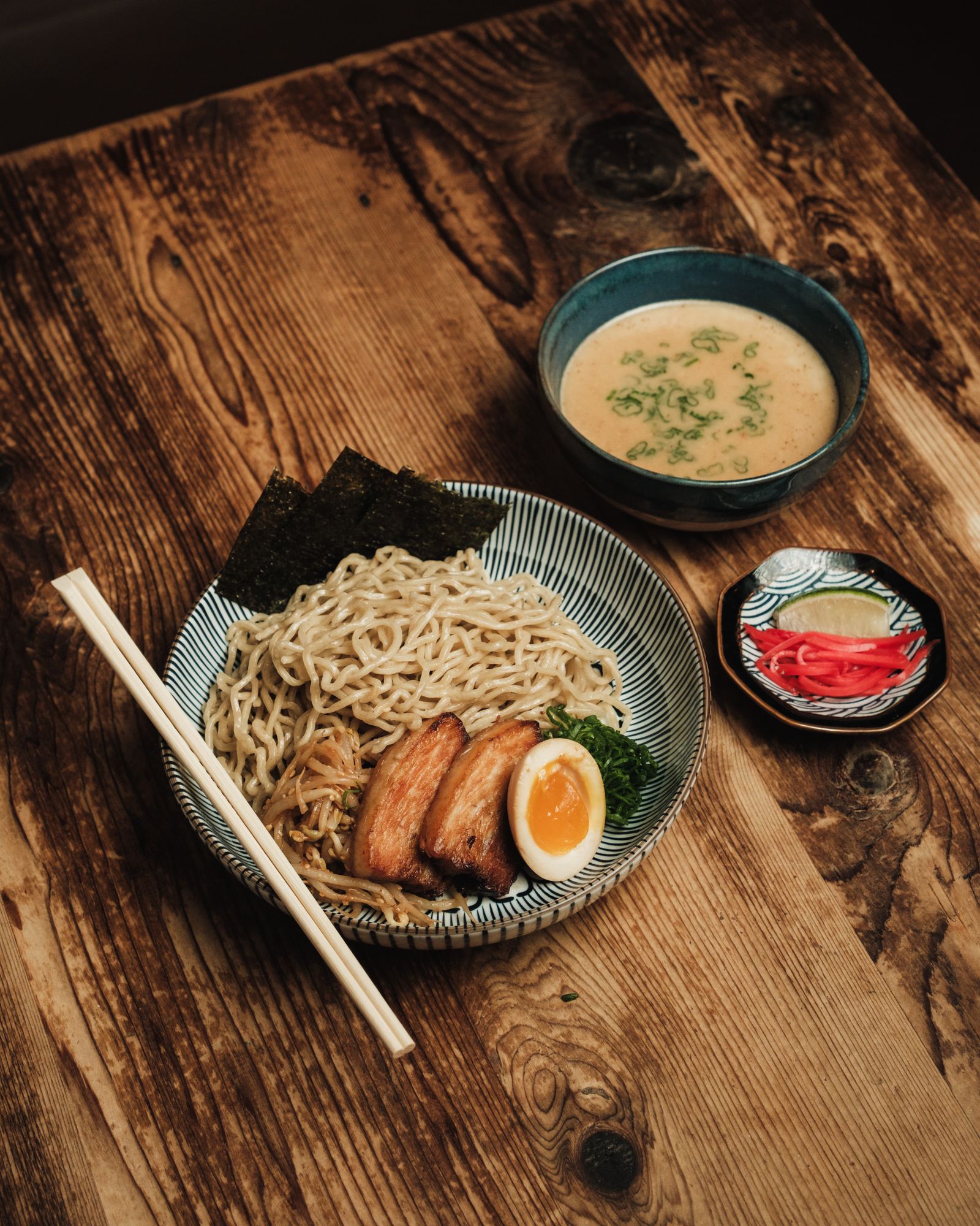 Steam rising over ramen at the counter