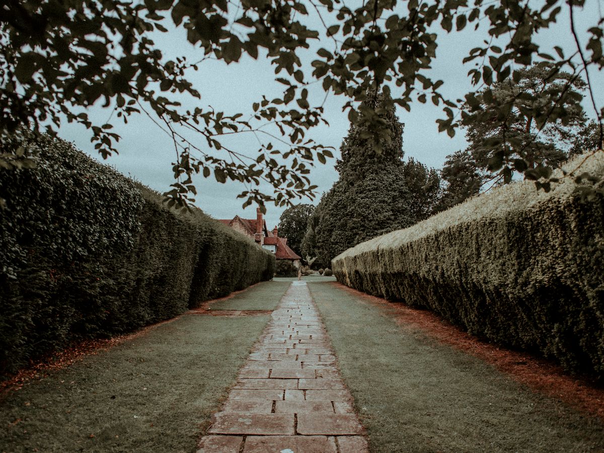 Curved paver pathway through garden beds
