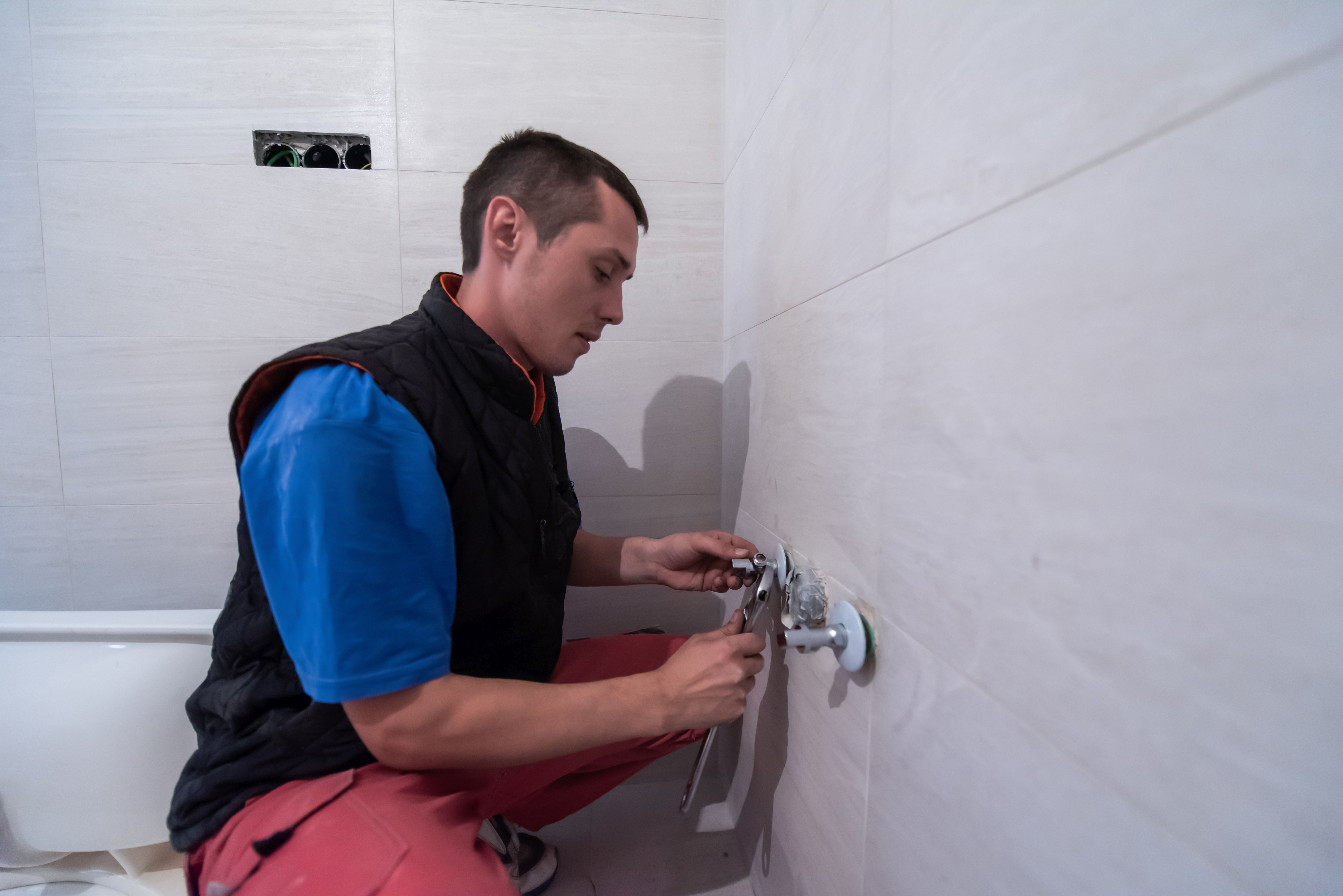 Plumber at work on a bathroom installation