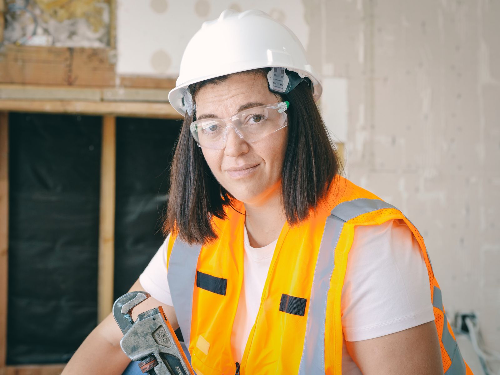 Plumfast tradesperson holding a pipe wrench on site in Adelaide