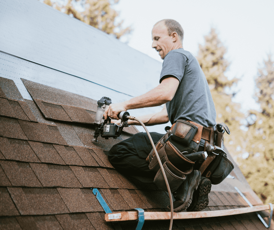 Roofer replacing damaged roofing