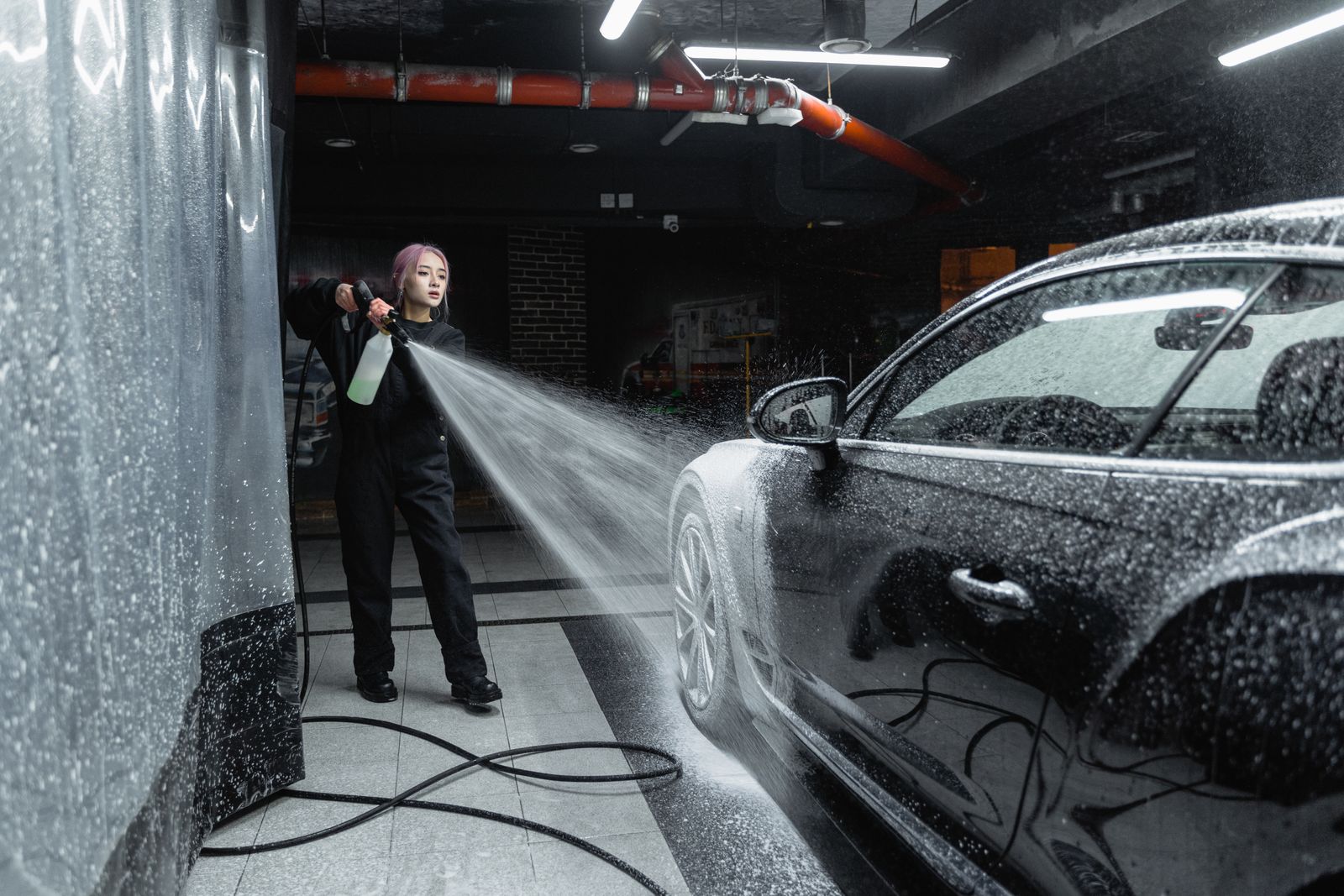 Foam wash in progress on a black car during a mobile detail