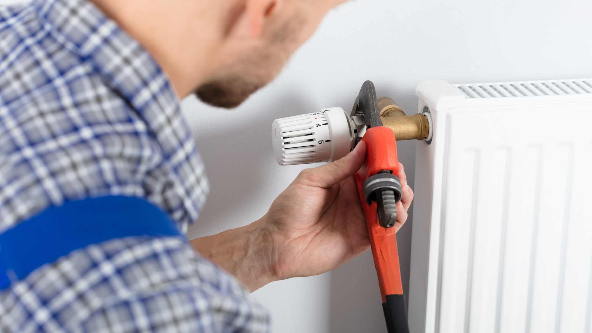 Heating engineer at work on a boiler