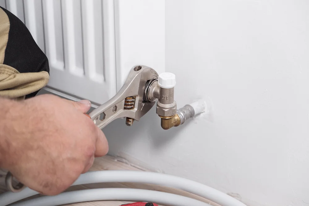 Engineer installing a central heating radiator