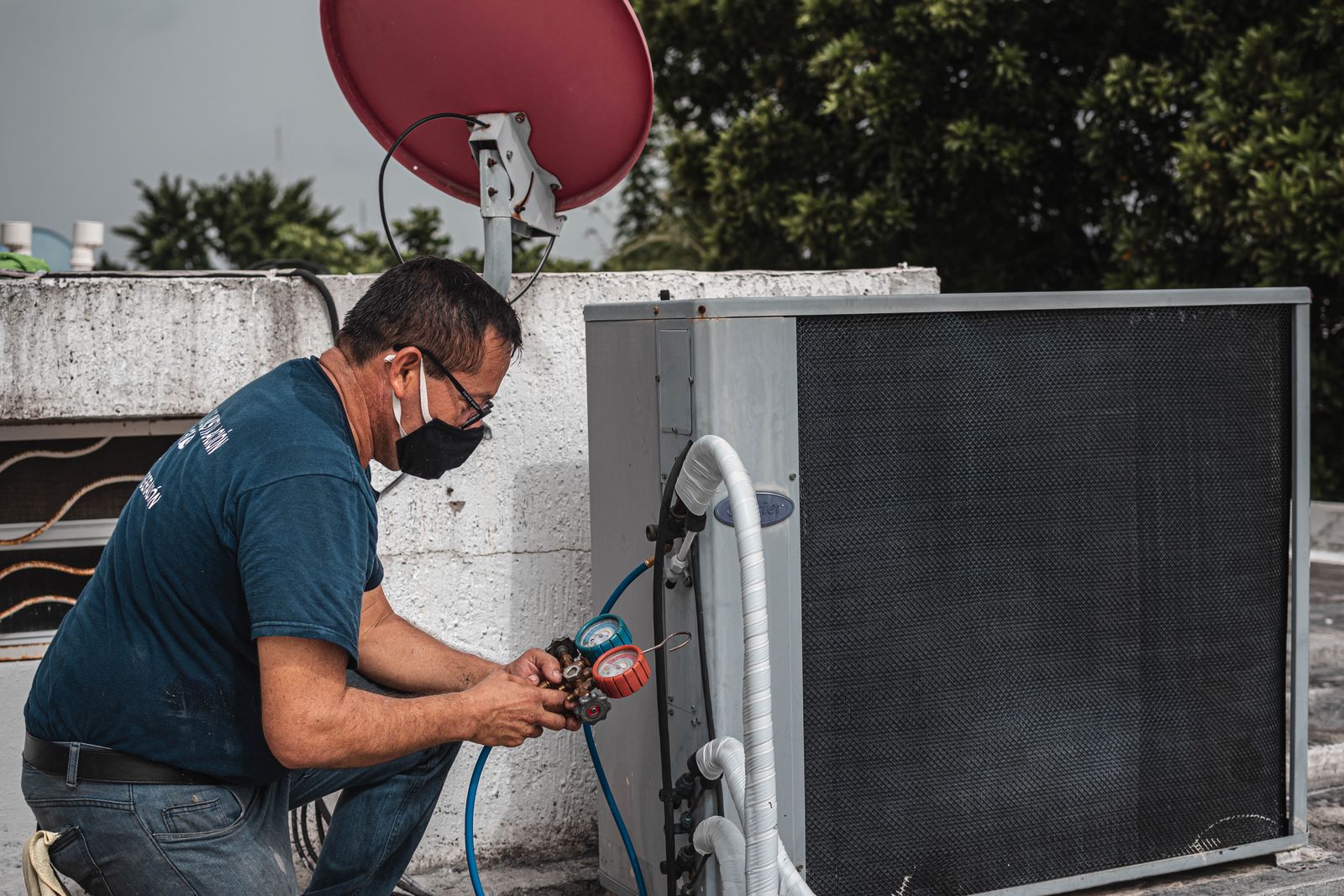 Illustrative stock photo: technician servicing a commercial air conditioning unit