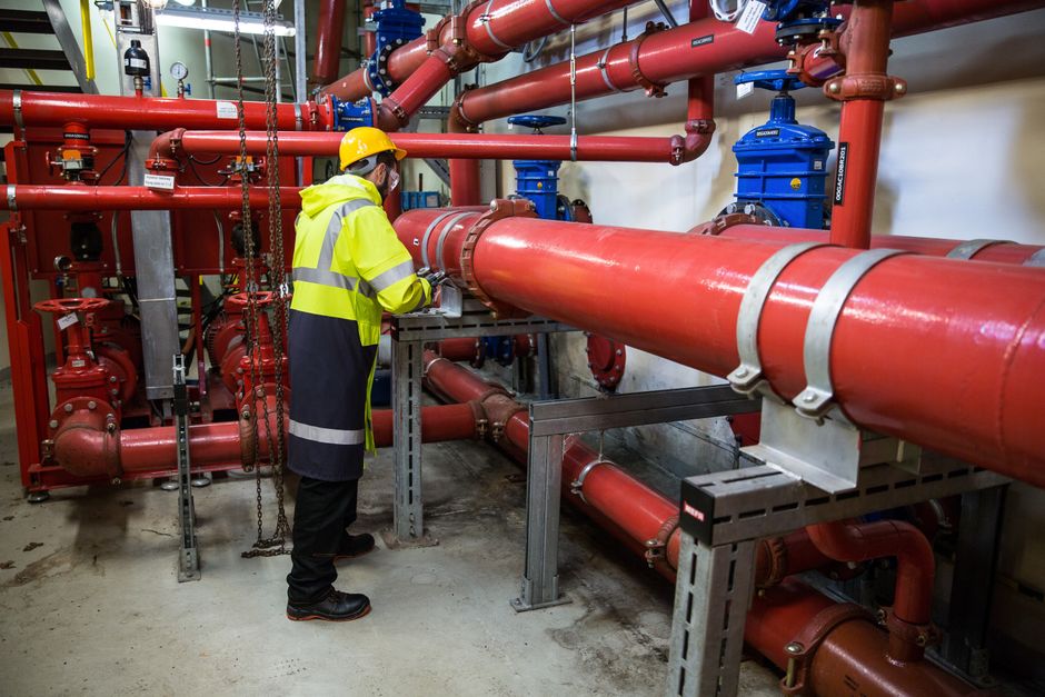 Plumber working on large pipework — Speedway Plumbing, Houston TX
