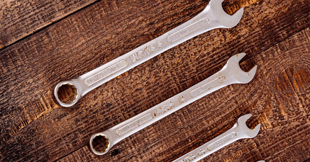 Wrenches laid out on the bench before a job